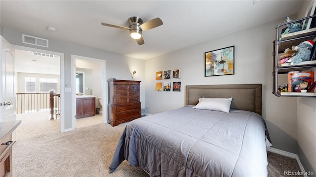 carpeted bedroom featuring ensuite bathroom and ceiling fan