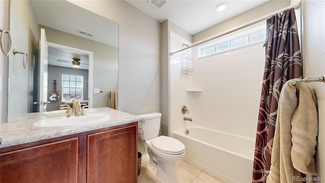 full bathroom with ceiling fan, tile patterned floors, shower / bath combination with curtain, toilet, and vanity