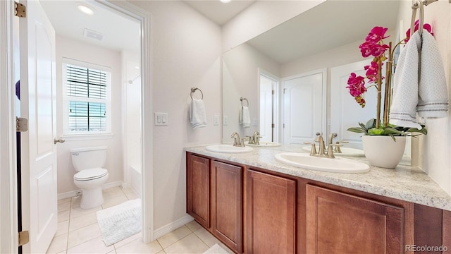 full bathroom featuring tile patterned floors, vanity, toilet, and washtub / shower combination