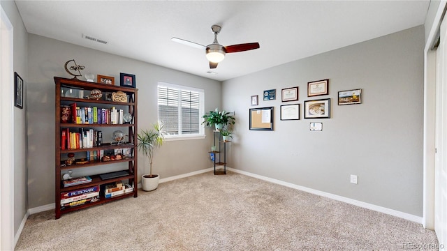 misc room featuring light colored carpet and ceiling fan