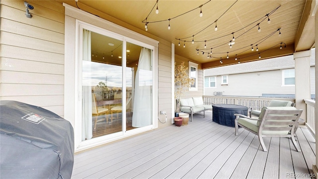 wooden deck featuring a grill