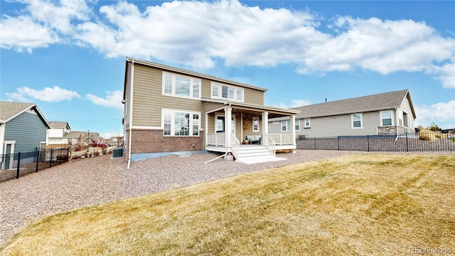 rear view of house with cooling unit and a lawn