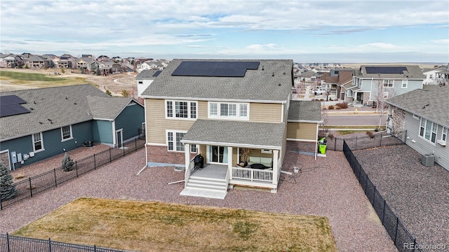 view of front of house featuring a front yard and solar panels