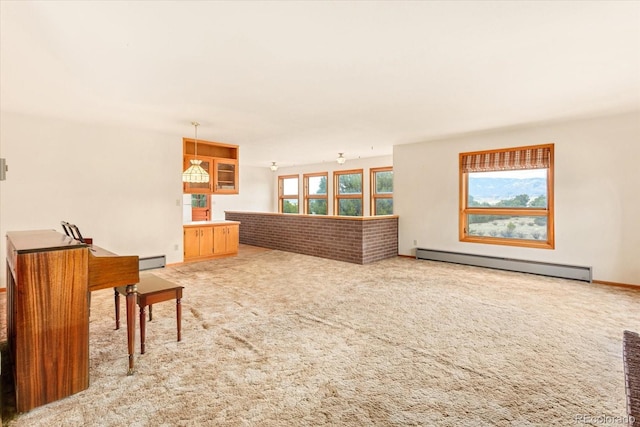 interior space featuring carpet flooring and a baseboard heating unit