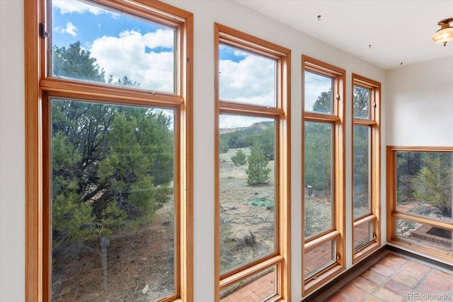 doorway to outside with tile floors