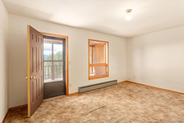 carpeted empty room with a baseboard radiator