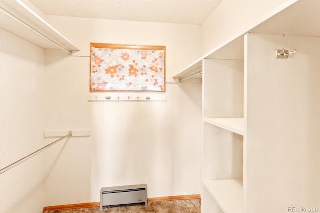 walk in closet with a baseboard radiator