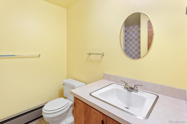 bathroom with vanity, tile floors, toilet, and baseboard heating