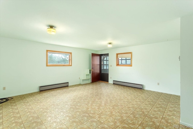 unfurnished room with light tile flooring and a baseboard heating unit