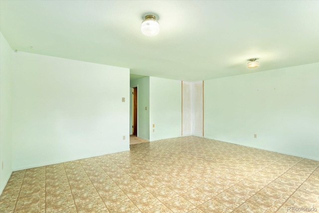 unfurnished room featuring light tile floors