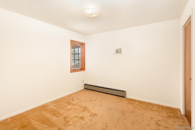 carpeted spare room with baseboard heating