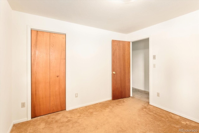 unfurnished bedroom with a closet and carpet flooring