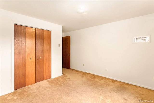 unfurnished bedroom with carpet and a closet