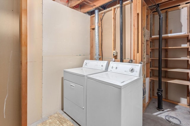 clothes washing area featuring separate washer and dryer