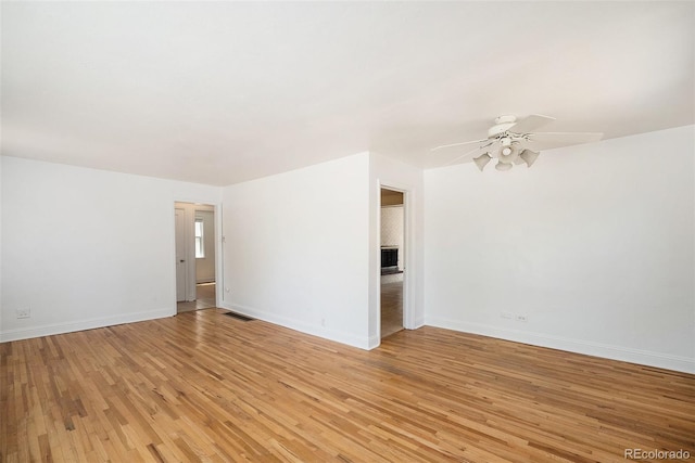 1355 Rosemary St, Denver, CO 80220 - spare room featuring ceiling fan, light wood-style flooring, baseboards, and a fireplace