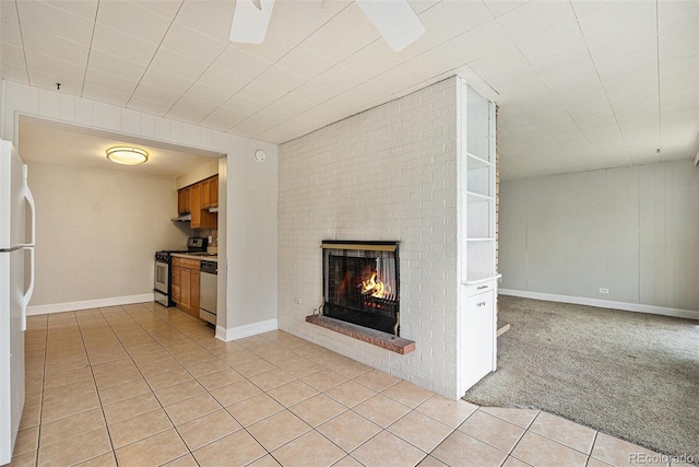 1355 Rosemary St, Denver, CO 80220 - unfurnished living room featuring a fireplace, light tile patterned floors, a ceiling fan, and baseboards