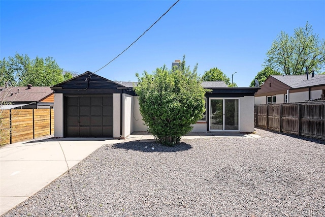 1355 Rosemary St, Denver, CO 80220 - view of front facade featuring stucco siding, concrete driveway, a garage, and a chimney