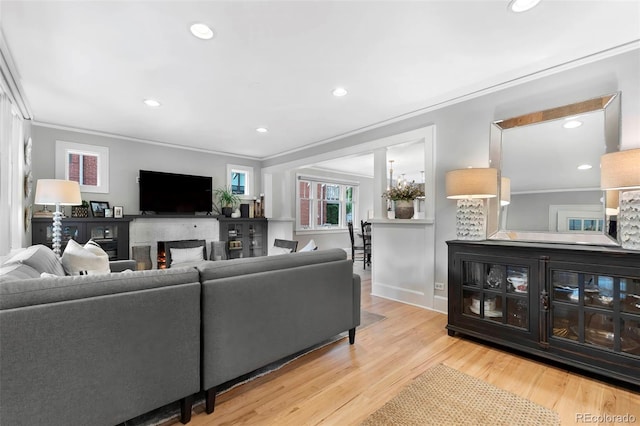 3341 Newton St, Denver, CO 80211 - living area featuring a fireplace, ornamental molding, wood finished floors, recessed lighting, and baseboards