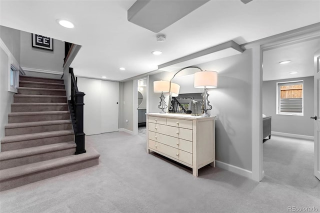 3341 Newton St, Denver, CO 80211 - below grade area with light carpet, baseboards, recessed lighting, and stairs