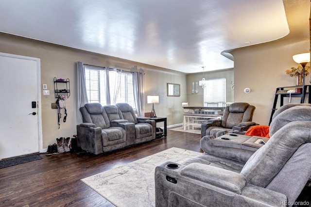 living room featuring dark hardwood / wood-style floors and an inviting chandelier