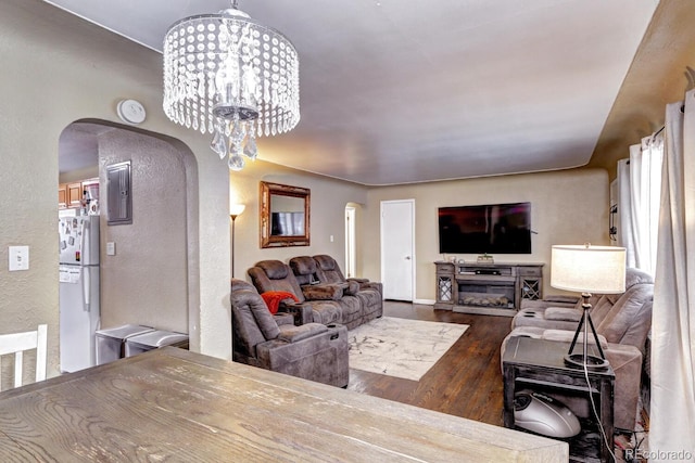 living room featuring electric panel, hardwood / wood-style floors, and an inviting chandelier