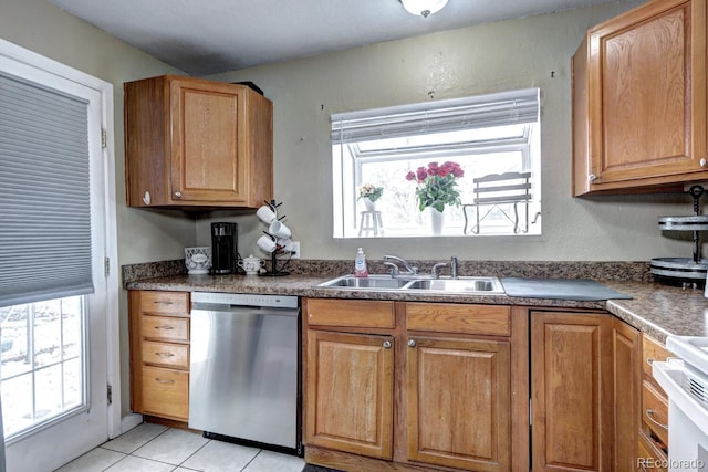 kitchen with light tile patterned floors, stove, stainless steel dishwasher, and sink