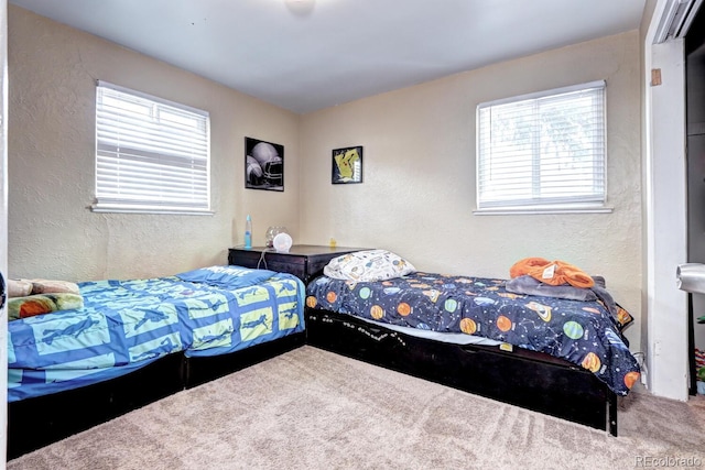 carpeted bedroom featuring multiple windows