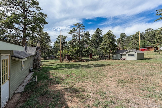 view of yard with an outdoor structure and a storage shed