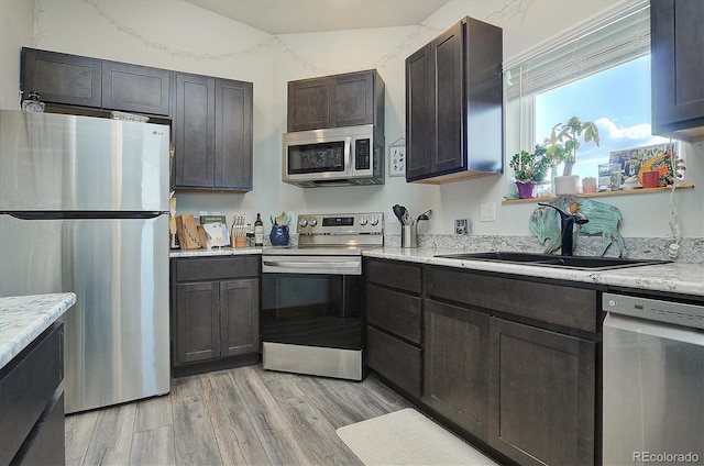 146 Raven Way, Buena Vista, CO 81211 - kitchen with stainless steel appliances, a sink, light wood finished floors, and dark brown cabinetry