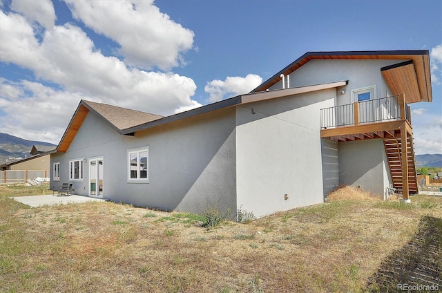 146 Raven Way, Buena Vista, CO 81211 - rear view of property with stairs, stucco siding, a patio, and a mountain view