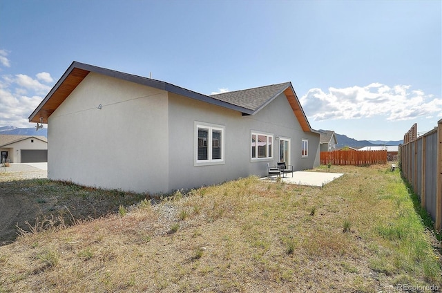 146 Raven Way, Buena Vista, CO 81211 - rear view of house with a patio area, stucco siding, and a shingled roof