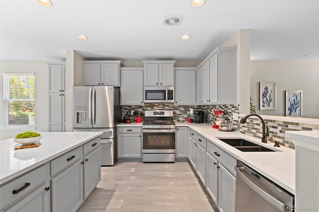 24738 E Layton Pl, Aurora, CO 80016 - kitchen featuring appliances with stainless steel finishes, a sink, light countertops, backsplash, and recessed lighting