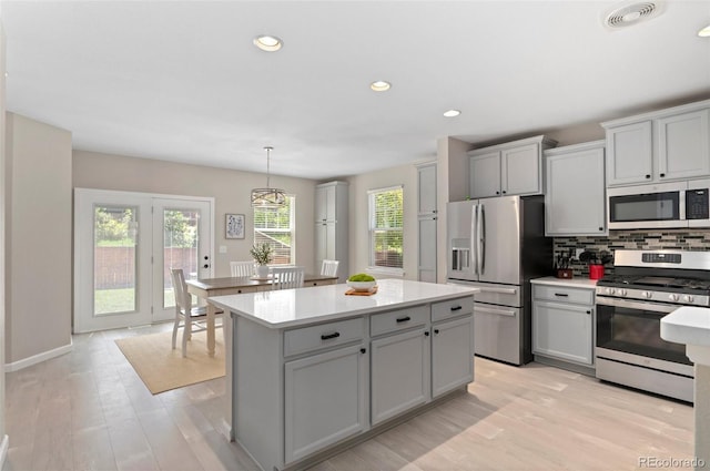 24738 E Layton Pl, Aurora, CO 80016 - kitchen featuring appliances with stainless steel finishes, light countertops, gray cabinets, backsplash, and recessed lighting