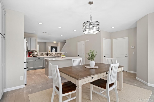 24738 E Layton Pl, Aurora, CO 80016 - dining space featuring light wood-style floors, a chandelier, baseboards, and recessed lighting