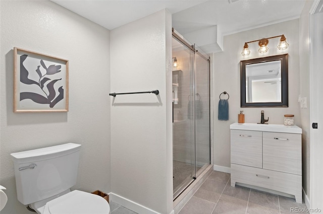 24738 E Layton Pl, Aurora, CO 80016 - bathroom featuring toilet, tile patterned flooring, a stall shower, vanity, and baseboards