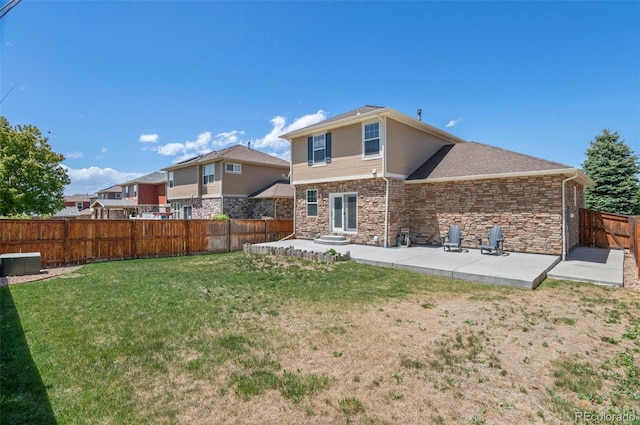 24738 E Layton Pl, Aurora, CO 80016 - rear view of property featuring a patio, stone siding, and a shingled roof