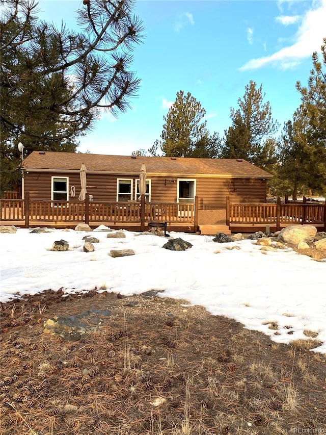 log cabin with a wooden deck