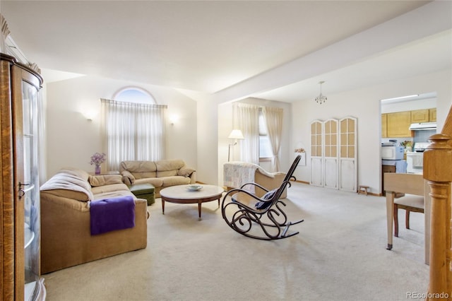 carpeted living room with a notable chandelier