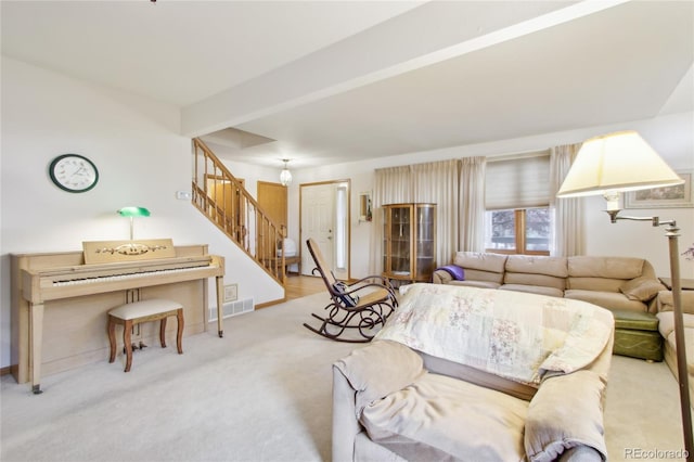 living room with light colored carpet and beamed ceiling