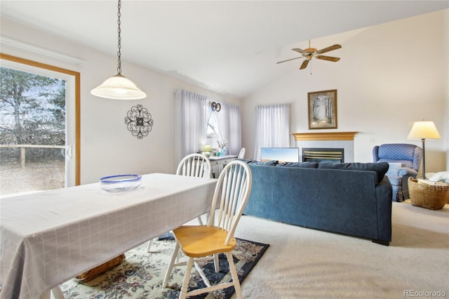 carpeted dining space featuring ceiling fan, lofted ceiling, and plenty of natural light