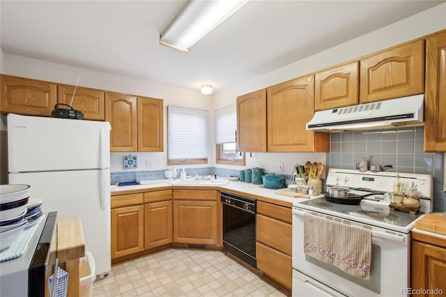 kitchen with sink, white appliances, and backsplash