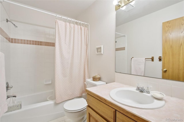 full bathroom featuring toilet, vanity, shower / bath combination with curtain, and tasteful backsplash