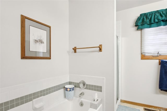 bathroom with a tub to relax in