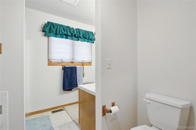 bathroom featuring toilet and vanity