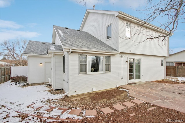 snow covered property with a patio area