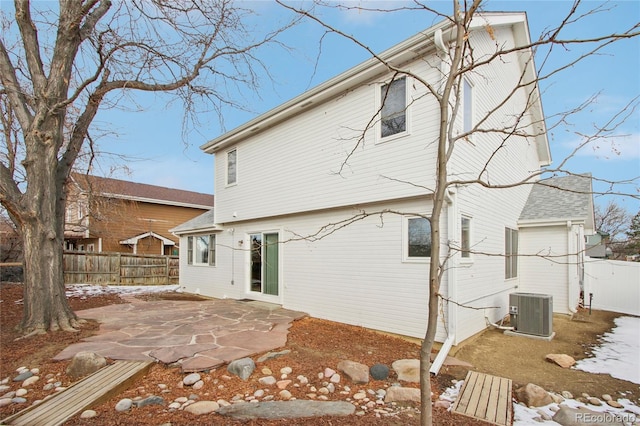 back of property featuring a patio and central AC