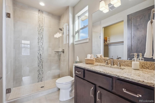 full bath featuring vanity, a shower stall, and toilet