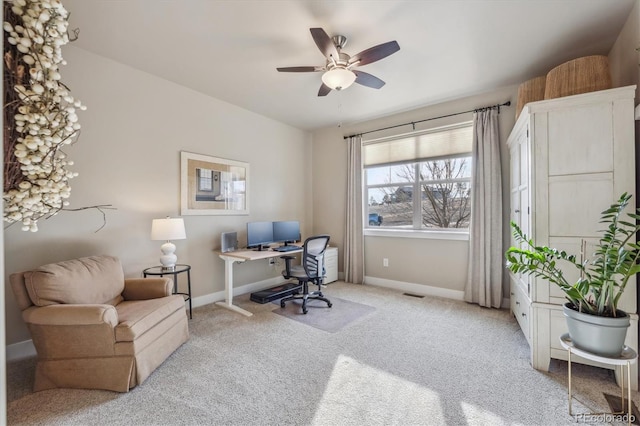 carpeted office space featuring visible vents, ceiling fan, and baseboards