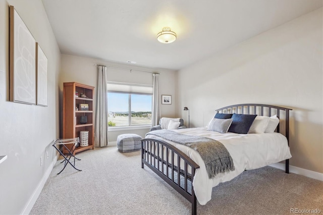 carpeted bedroom featuring baseboards