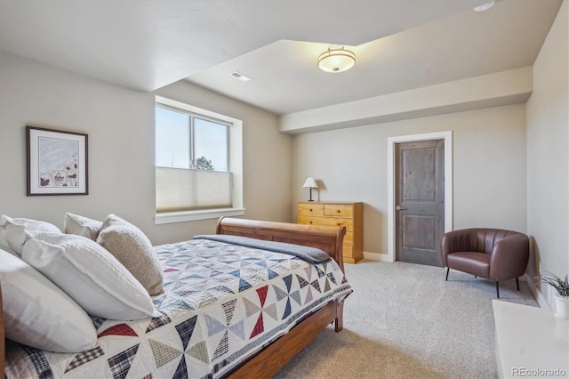 carpeted bedroom with visible vents and baseboards